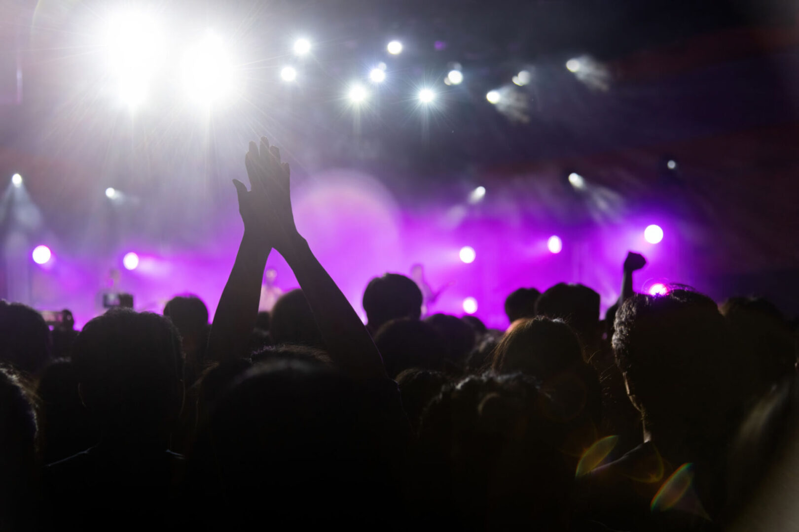 Concert crowd with bright stage lights.
