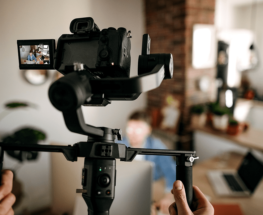 Camera on stabilizer recording a person indoors.