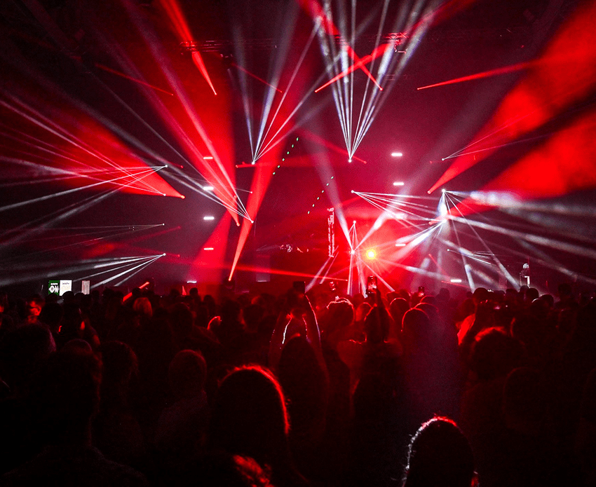 Concert with vibrant red stage lighting effects.