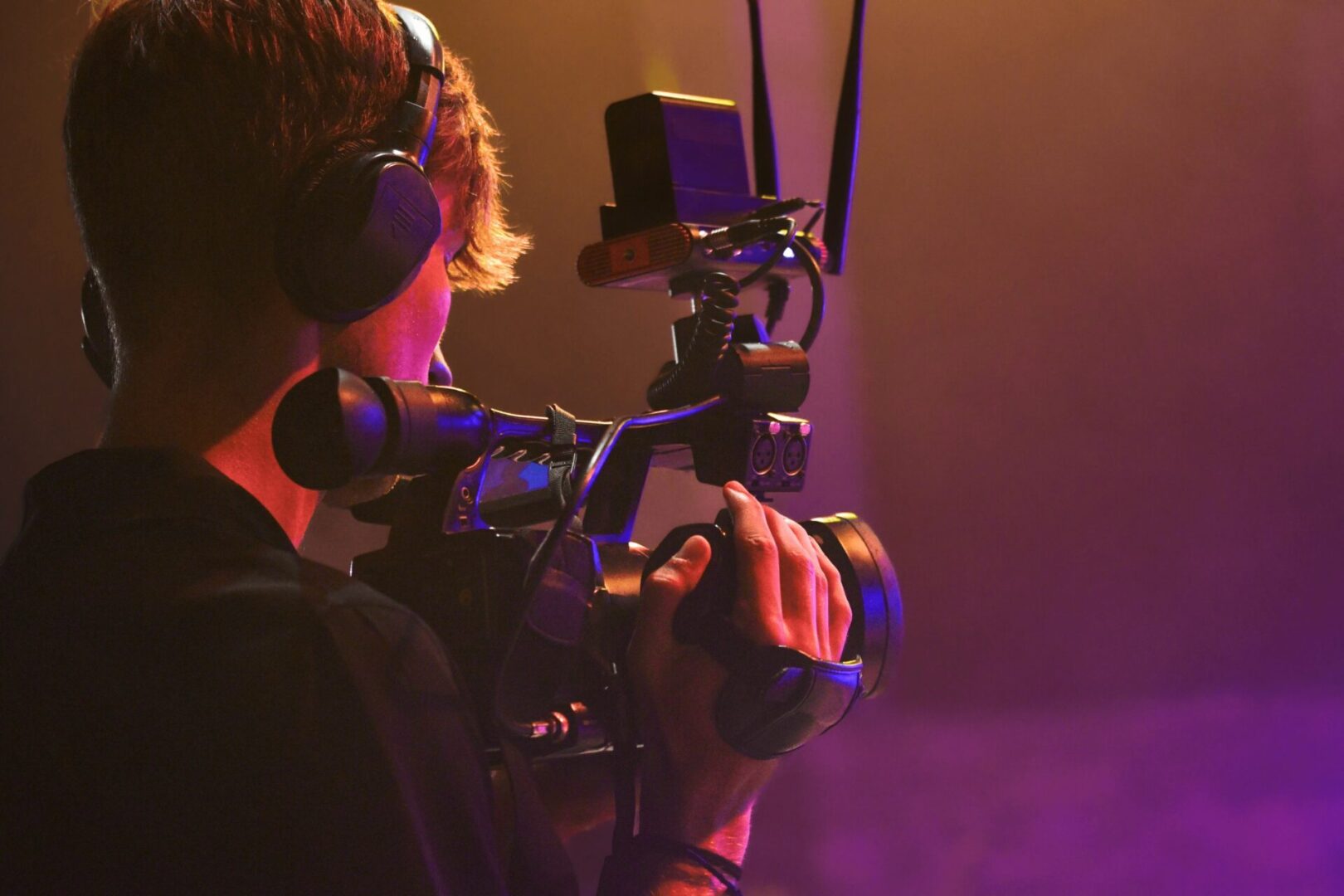 Cameraperson recording with professional video camera.