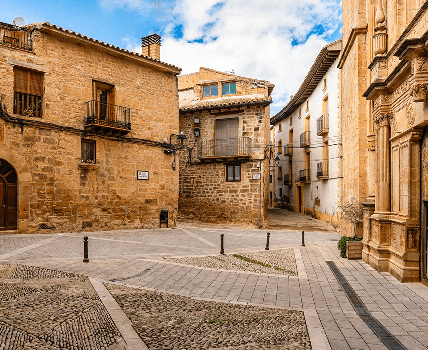 Historic European village street with stone buildings.
