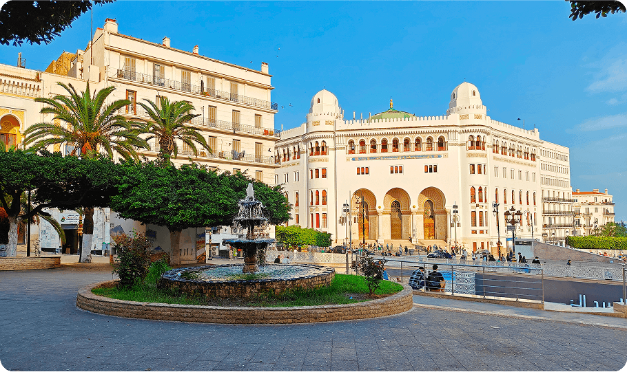 Historic building and fountain in sunny plaza.