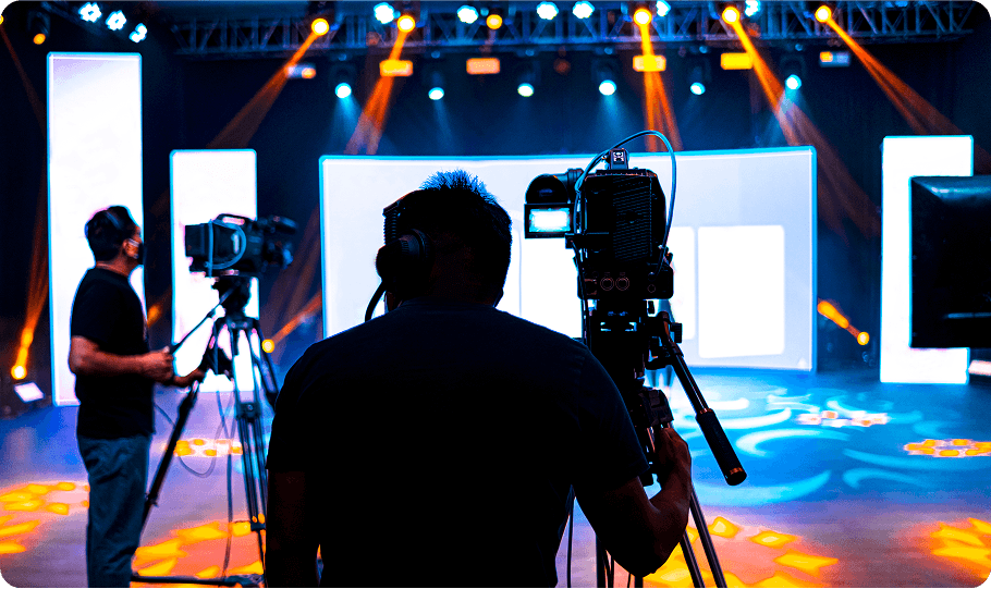 Camera crew filming in a studio setting.